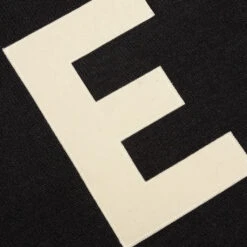 Essentials Kid's Big E Knit Polo - Iron -Feature Clothing Fear of God Essentials Kid s Big E Sweater Iron 785BT214320K 07 06 22 Feature VR 2 a13e64d9 d3f4 43c0 8fad 6d25c992d90e