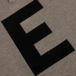 Essentials Kid's Big E Knit Polo - Dark Oatmeal -Feature Clothing Fear of God Essentials Kid s Big E Knit Polo Dark Oatmeal 785BT214333K 08 03 22 Feature VR 2