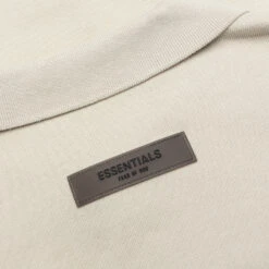 Essentials Kid's L/S Polo - Wheat 11 Essentials Kid's L/S Polo - Wheat -Feature Clothing Fear of God Essentials Kid s L S Polo Wheat 785BT214192K 05 05 22 Feature 7